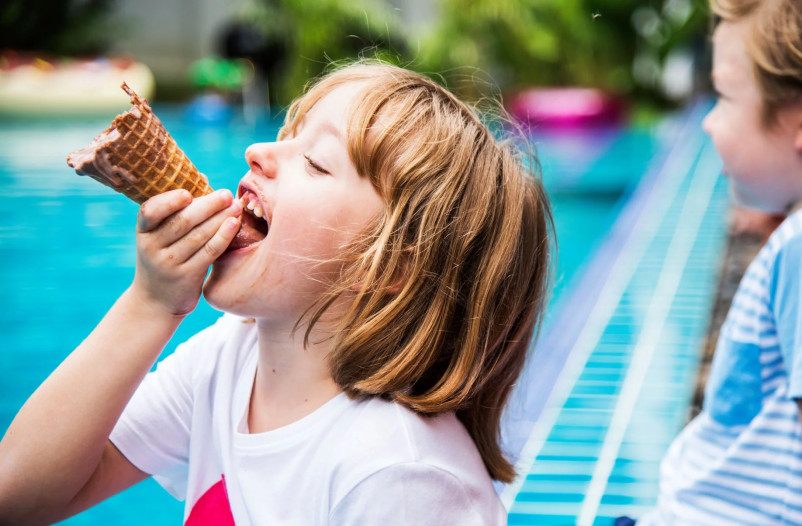 media.closeup-caucasian-girl-eating-ice-cream-by-pool (1)